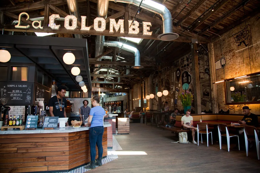 La Colombe cafe in SoHo, New York City, with modern minimalist decor, communal seating, and signature draft lattes.