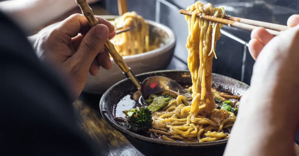 A bowl of authentic Japanese ramen with rich broth, noodles, sliced pork, and a soft-boiled egg.
